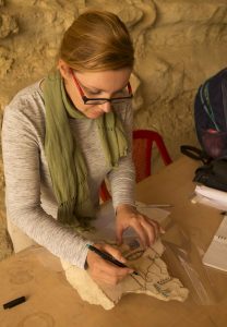 Veronika Dulíková dokumentuje nápis na fragmentu reliéfní výzdoby pocházející z hrobky královského kadeřníka Anchirese, objevené během podzimní expedice 2016 (foto Martin Frouz).